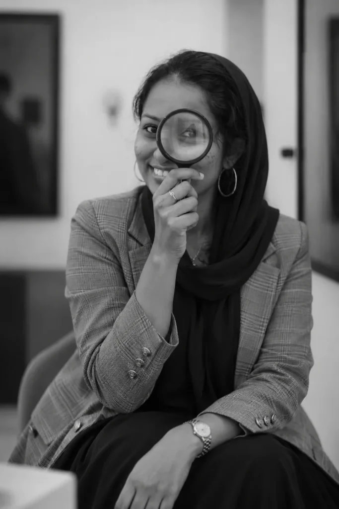 Freelance SEO Analyst in Ernakulam- professional portrait of Thayyiba holding a lens